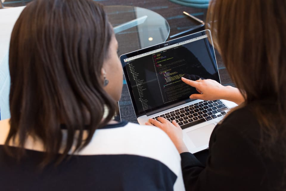 A developer working on code at a laptop